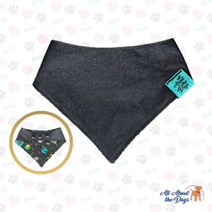 May include: A black bandana with a space-themed print and a turquoise label that says "All About the Dogs".