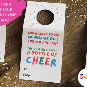 May include: Set of four printable holiday wine tags. One tag reads "When what to my wondering eyes should appear? The best gift ever - a bottle of CHEER." Includes space to write "To" and "From". The Smirk Shop logo is in the bottom right.