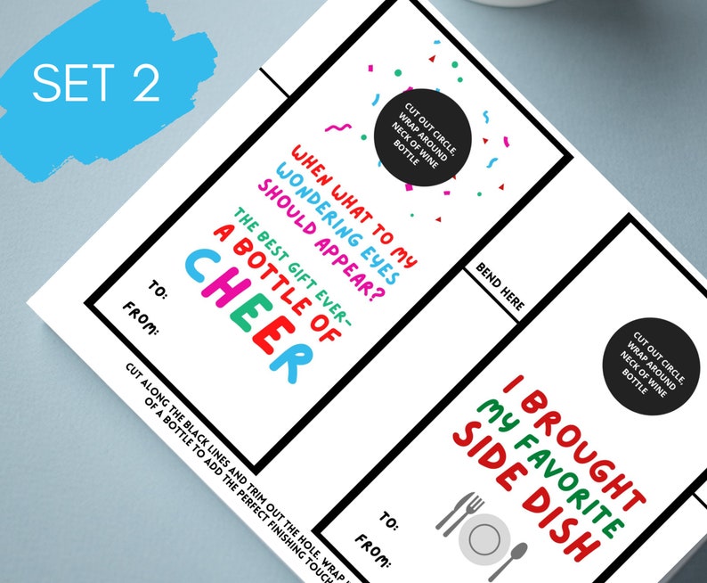 May include: Set of two printable gift tags with black borders. One tag reads "A Bottle of Cheer" in colorful letters. The other says "I Brought My Favorite Side Dish." Both have space for "To" and "From" and instructions to wrap around a wine bottle.