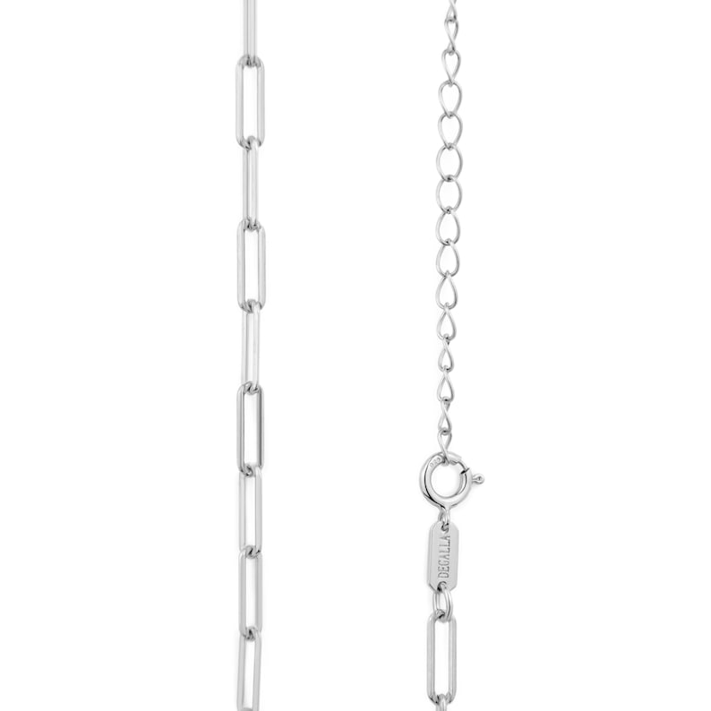 May include: A silver chain necklace featuring a rectangular link design. The necklace has a delicate chain with a lobster clasp closure and an adjustable chain. The brand name "DECALLA" is engraved on the clasp.