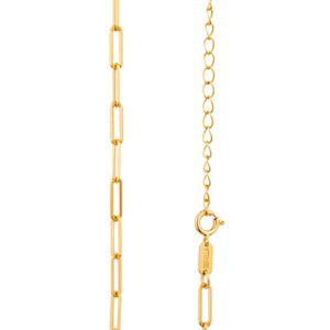May include: A gold-coloured necklace featuring a paperclip chain design. The necklace has an elongated link pattern. The clasp and extender chain are visible. The brand name "DECALLA" is engraved on the clasp.