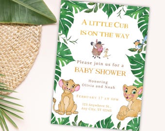 May include: A baby shower invitation with a jungle theme. The invitation features a green leafy border with a lion, a warthog, and a meerkat from the movie The Lion King. The text reads "A Little Cub Is On The Way" and "Please join us for a Baby Shower Honoring Olivia and Noah". The date and time of the shower are listed as "February 17 at 6pm" and the address is "123 Anywhere St., Any City, ST 12345".