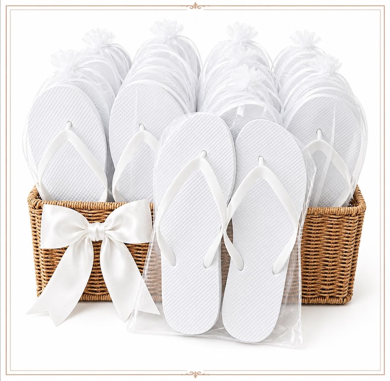 May include: A collection of white flip-flops, each individually wrapped in clear plastic bags, arranged inside a rectangular woven wicker basket. A large, white satin ribbon bow is attached to the front of the basket, which holds multiple pairs of footwear.