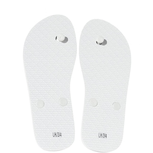 May include: A pair of plain white flip-flops featuring a textured diamond pattern on the footbed and a central toe post. The heel area of each sandal is clearly printed with the text UK/3/4, indicating the size for these white rubber sandals.