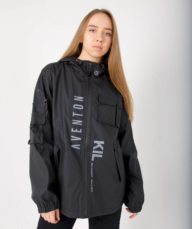 May include: Black hooded jacket with a zipper closure and two large pockets. The jacket has the text "KIL" and "AVENTON" printed vertically on the front.
