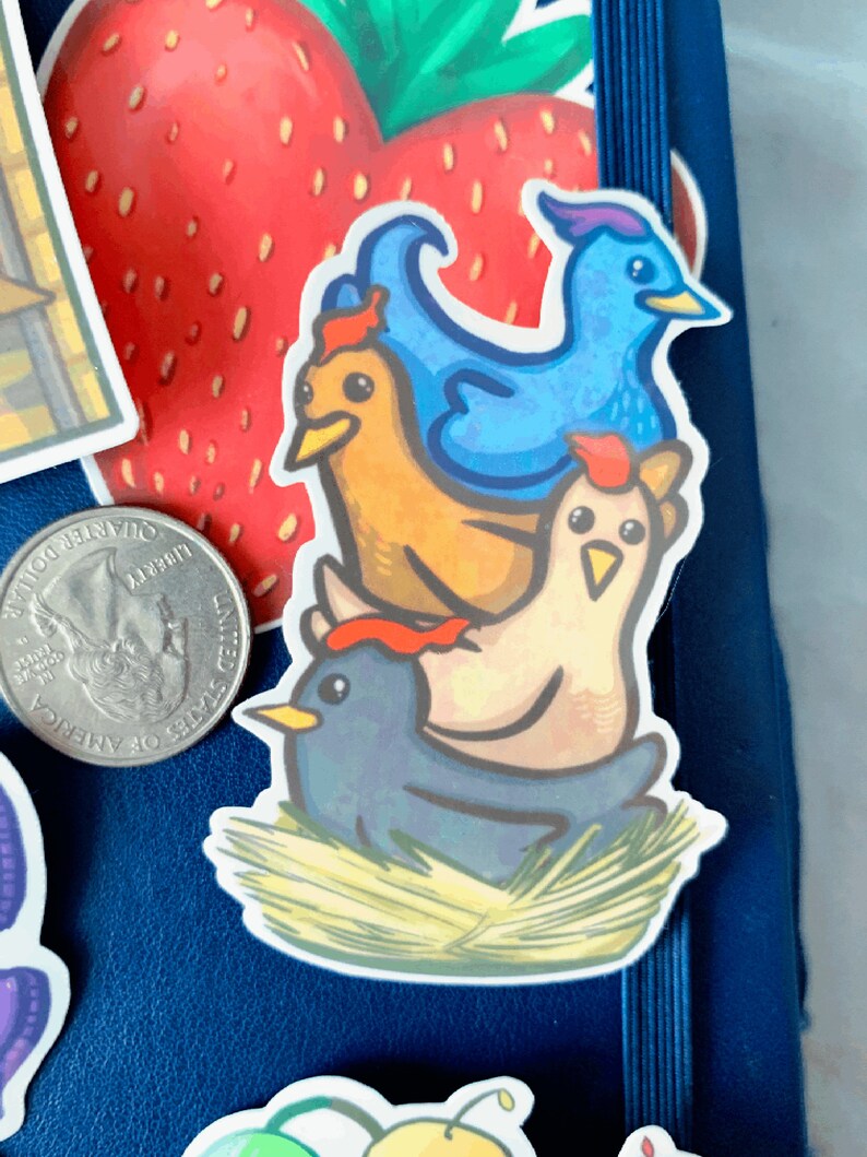 May include: A sticker featuring a stack of four cartoon birds. The bottom bird is blue, the next is brown, the next is white with a red comb, and the top bird is blue with a long, pointed beak. The birds are sitting on a bed of straw.