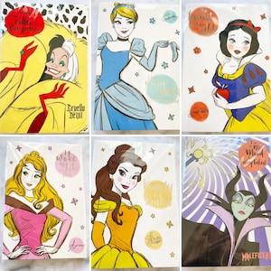 May include: Set of 10 Disney princess and villain themed notebooks. Each notebook features a different character with a quote. The characters include Cruella De Vil, Cinderella, Snow White, Aurora, Belle, and Maleficent.