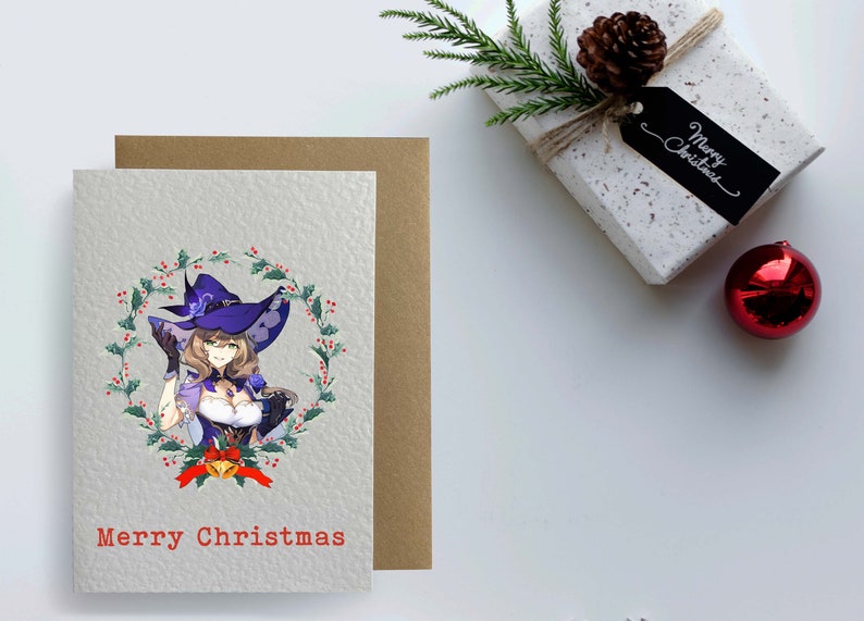 May include: A Christmas card featuring a woman with long brown hair wearing a purple and black witch hat and a white dress with a purple bodice. She is surrounded by a wreath of holly and berries. The card reads "Merry Christmas".