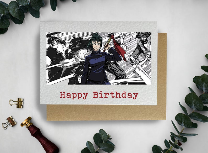 May include: A birthday card featuring a black and white manga style illustration of a woman with green hair and glasses holding a weapon. The text "Happy Birthday" is printed in red at the bottom of the card.