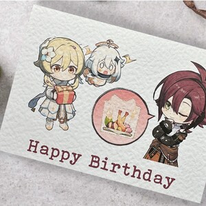May include: A birthday card with a cartoon illustration of three characters. The card has the text "Happy Birthday" on it.