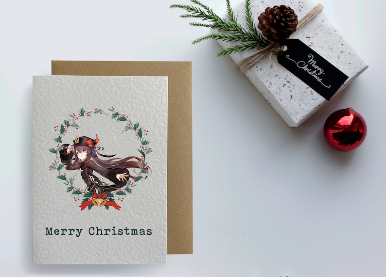 May include: A Christmas card featuring an anime-style illustration of a woman in a black and red outfit with a wreath of holly and berries around her. The text "Merry Christmas" is printed below the illustration.