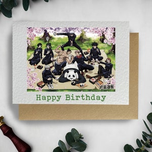 May include: A birthday card featuring a group of anime characters having a picnic with a panda. The card has a green background with the text "Happy Birthday" in green.