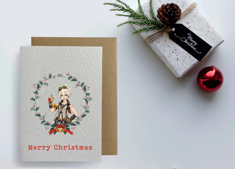 May include: A Christmas card featuring a cartoon character with blonde hair and a red and green holly wreath. The card has the text "Merry Christmas" in red.