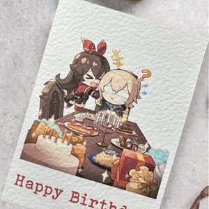 May include: A birthday card featuring a cartoon illustration of two anime characters, one with long black hair and a red bow, and the other with long blonde hair, celebrating with a cake and gifts. The card reads "Happy Birthday".