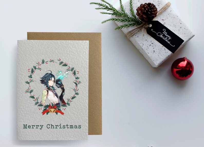 May include: A Christmas card featuring a character with blue hair and a green and red wreath with holly berries. The card has the text "Merry Christmas" at the bottom.