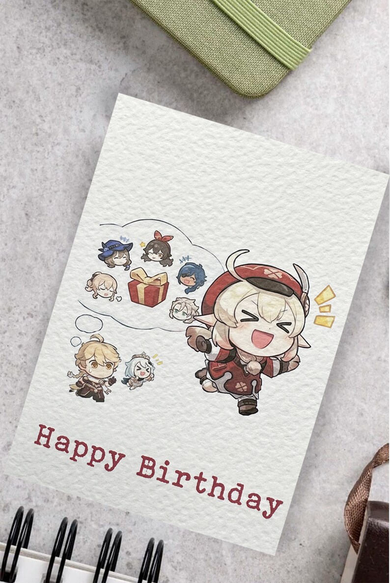 May include: A birthday card with a cartoon illustration of a character with blonde hair and red horns. The character is wearing a red and white outfit and is holding a gift box. The card has the text "Happy Birthday" in red.