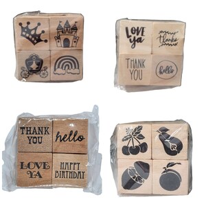 May include: Four sets of wooden stamps with various designs and phrases. The first set features a crown, a castle, a carriage, and a rainbow. The second set features the phrases "Love ya", "Thanks", "Thank You", and "Hello". The third set features the phrases "Thank You", "Hello", "Love Ya", and "Happy Birthday". The fourth set features a bunch of cherries, a pear, a lemon, and an orange.