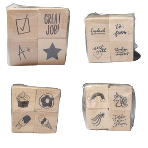 May include: Set of 12 wooden stamps with various designs, including a star, a checkmark, a cupcake, a donut, a rainbow, a unicorn, and text like "Great Job!" and "Handmade with Love By:".