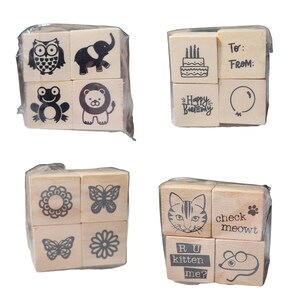 May include: Set of 12 wooden stamps with various designs, including animals, flowers, butterflies, and birthday greetings. The stamps are packaged in clear plastic bags.