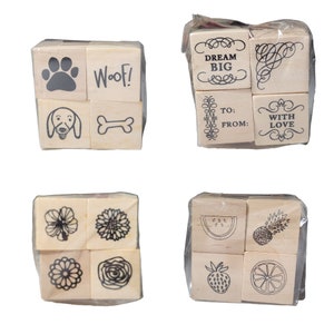 May include: Set of 10 wooden rubber stamps with various designs, including paw prints, a bone, a dog, flowers, a watermelon, a pineapple, a strawberry, and a lemon. The stamps are packaged in clear plastic bags.