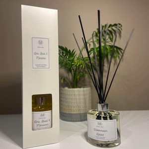 May include: A white box and a glass diffuser bottle with black reeds. The box has a label that reads "Lime, Basil & Mandarin". The diffuser bottle has a label that reads "Watermelon Lollies". Both labels have the Eden's Aura logo.