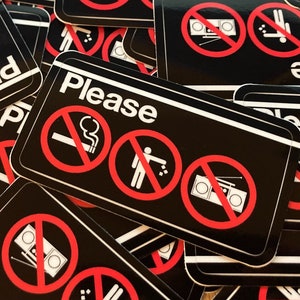 May include: A set of black and white stickers with the word "Please" and red circle symbols with a line through them. The symbols include a cigarette with smoke, a person throwing something away, and a boombox.