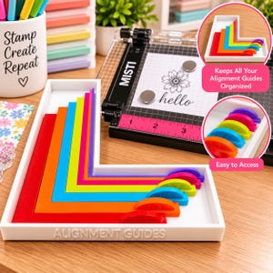 May include: A white rectangular tray containing six L-shaped alignment guides in red, orange, blue, yellow, pink, and purple. Each guide features a semi-circular handle with embossed imperial measurements. The tray is labeled ALIGNMENT GUIDES.