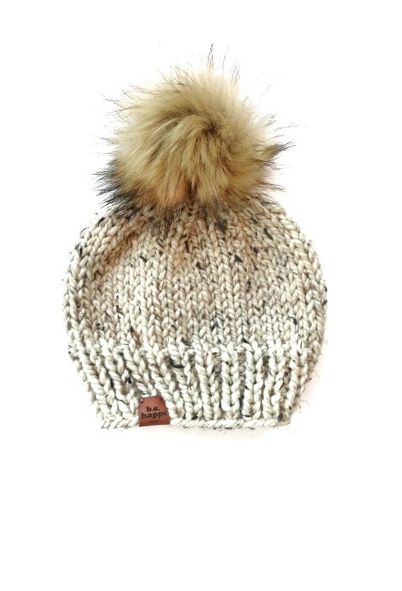 cream hat with fur pom pom