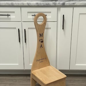May include: A wooden step stool with a carved heart and the initials "M & A" and the date "December 25, 2022".