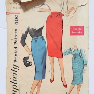 May include: Vintage Simplicity sewing pattern envelope. The envelope shows illustrations of pencil skirts in red, blue, and plaid. The text on the envelope includes "Waist 26", "Hip 36", and "Simple to make". The pattern number is 2703.
