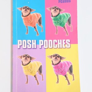 May include: A softcover book titled Posh Pooches by Trixie + Peanut featuring 12 knitting patterns for the well-dressed dog. The cover displays four photographs of a small dog wearing knitted jumpers in orange, green, yellow, and pink.