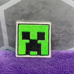 May include: Green embroidered patch with a black Minecraft Creeper face.