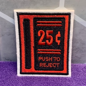 May include: Red and black embroidered patch with the text "25¢" and "PUSH TO REJECT".
