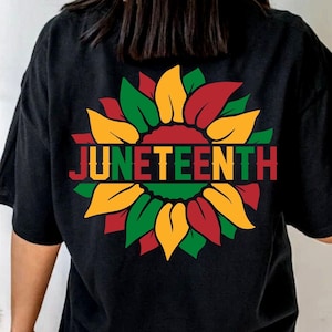 May include: Black t-shirt with a red, yellow, and green sunflower graphic and the text "Juneteenth" in a white outline.