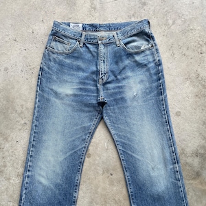 May include: Faded blue denim jeans with a classic five-pocket design. The jeans show signs of wear and fading, with a button and zipper closure. The jeans have a straight leg cut and are suitable for casual wear.