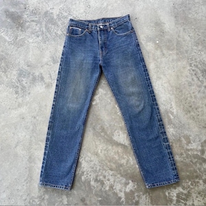 May include: Blue denim jeans with a classic five-pocket design. The jeans have a button and zipper closure, belt loops, and a straight leg fit. The denim has a faded wash, giving the jeans a vintage look. The jeans are made of durable denim.