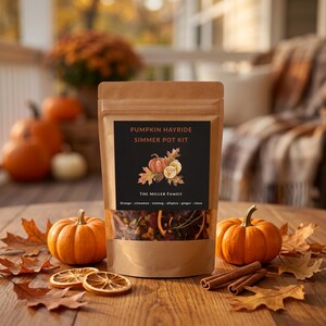 May include: A brown kraft paper pouch containing a Pumpkin Hayride Simmer Pot Kit. The black label features text, an illustration of a pumpkin and dried orange slices, and lists ingredients: orange, cinnamon, nutmeg, allspice, ginger, clove.