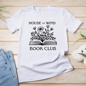 House of Wind book club on a white t shirt