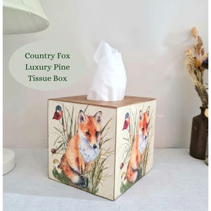 Country fox and robins luxury pine square tissue box this lovely tissue box has been primed and decoupaged in a country fox and robins design on all sides of the tissue box in a mix of greens browns reds orange cream and black with hints of gold wax gilding around the corners of the box, the top and inside the box have been waxed with a pull-out base to keep your tissues inside sealed all over to protect just wipe down with a damp cloth when needed Height 14 cm Width 15 cm Length 13 cm