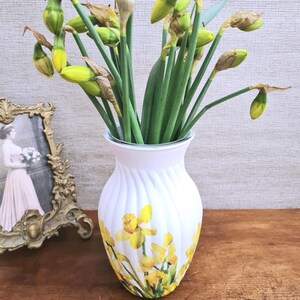 Spring Daffodils glass vase, A beautiful glass vase which has been decoupaged with vibrant yellow spring daffodils all around the vase creating a cheerful and uplifting display. set against a hand painted white chalk paint background giving it a rustic feel with natural twine tied around the vase. Height 20 cm width 11 cm