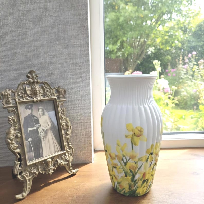 Tall large ribbed daffodil glass vase, A pretty daffodil long stemmed 26cm in height 14 cm width glass vase primed and painted in a white chalk paint providing the perfect backdrop for the decoupaged yellow daffodils all around the vase and is sure to bring a touch of nature and colour to any room