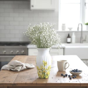 Tall large ribbed daffodil glass vase, A pretty daffodil long stemmed 26cm in height 14 cm width glass vase primed and painted in a white chalk paint providing the perfect backdrop for the decoupaged yellow daffodils all around the vase and is sure to bring a touch of nature and colour to any room