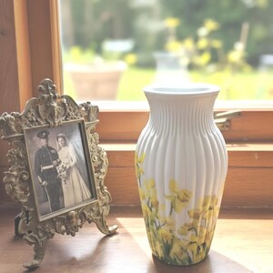 Tall large ribbed daffodil glass vase, A pretty daffodil long stemmed 26cm in height 14 cm width glass vase primed and painted in a white chalk paint providing the perfect backdrop for the decoupaged yellow daffodils all around the vase and is sure to bring a touch of nature and colour to any room