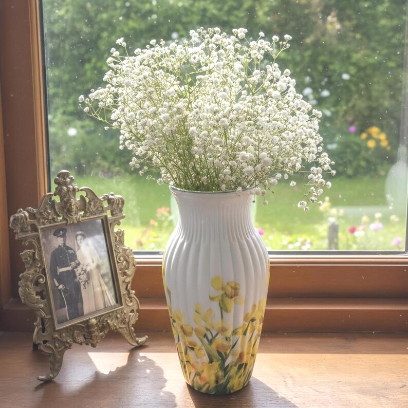 Tall large ribbed daffodil glass vase, A pretty daffodil long stemmed 26cm in height 14 cm width glass vase primed and painted in a white chalk paint providing the perfect backdrop for the decoupaged yellow daffodils all around the vase and is sure to bring a touch of nature and colour to any room
