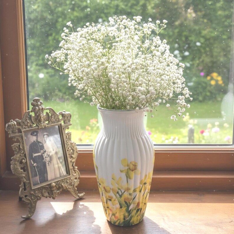 Tall large ribbed daffodil glass vase, A pretty daffodil long stemmed 26cm in height 14 cm width glass vase primed and painted in a white chalk paint providing the perfect backdrop for the decoupaged yellow daffodils all around the vase and is sure to bring a touch of nature and colour to any room