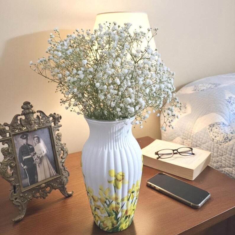 Tall large ribbed daffodil glass vase, A pretty daffodil long stemmed 26cm in height 14 cm width glass vase primed and painted in a white chalk paint providing the perfect backdrop for the decoupaged yellow daffodils all around the vase and is sure to bring a touch of nature and colour to any room