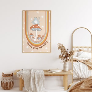May include: A framed print with a retro design featuring a blue frog sitting on a mushroom with the text "Never Stop Growing" in a rainbow arch.