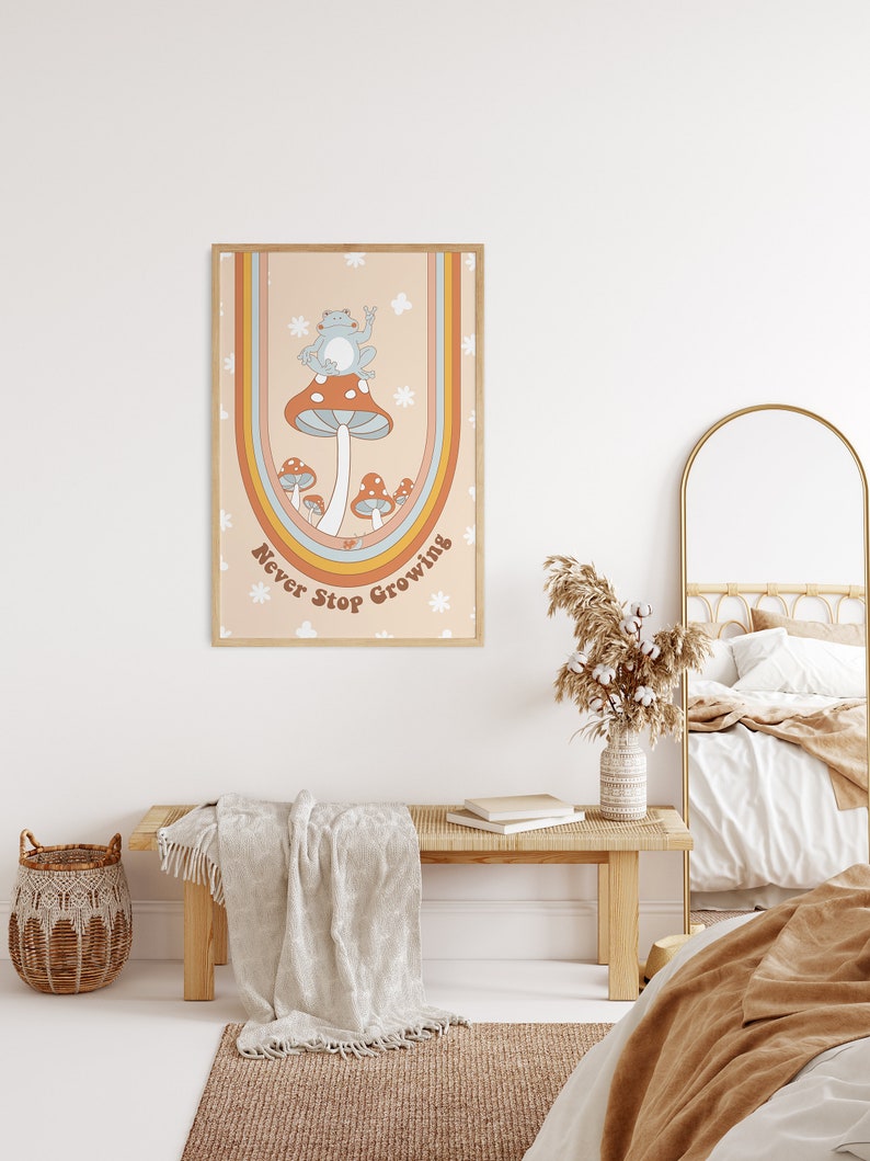 May include: A framed print with a retro design featuring a blue frog sitting on a mushroom with the text "Never Stop Growing" in a rainbow arch.