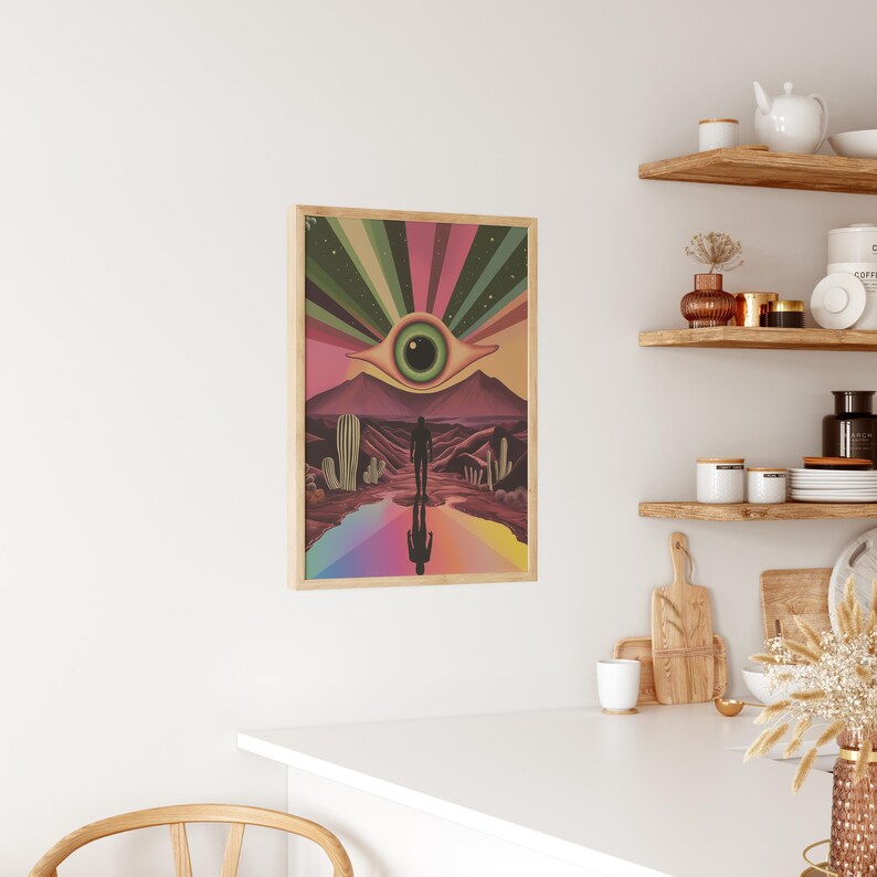 May include: A psychedelic art print featuring a large eye with a green iris and a pink eyelid, surrounded by a rainbow of colours. A silhouette of a person stands in front of the eye, with their reflection in the rainbow below. The background is a desert landscape with cacti.