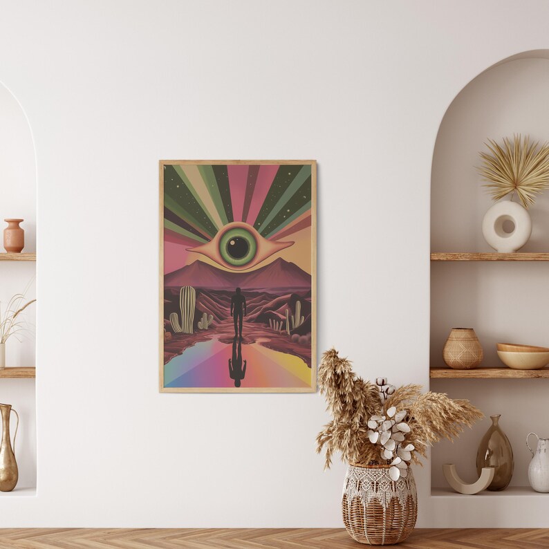 May include: A psychedelic art print featuring a large eye with a green iris, surrounded by a rainbow of colours. A silhouette of a person walks towards the eye in a desert landscape.
